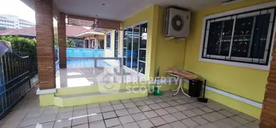 Charming outdoor patio with pool view and air conditioning unit, perfect for relaxation.