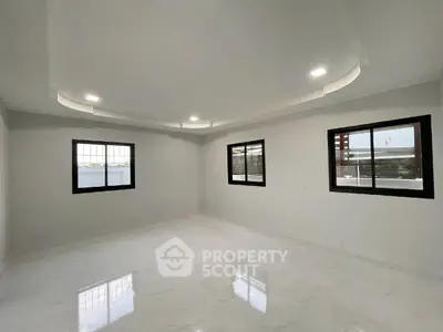 Spacious modern living room with elegant ceiling design and large windows