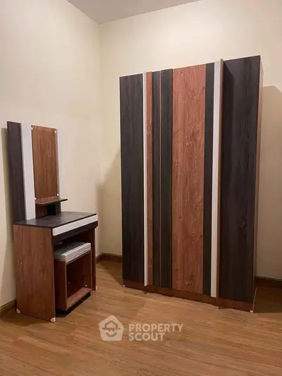 Modern bedroom furniture set with wardrobe and vanity in stylish wood finish.