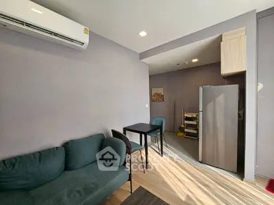 Modern living room with compact kitchen and sleek furniture