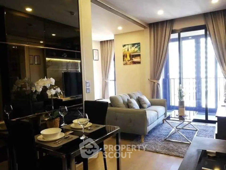 Modern living room with elegant decor and balcony view in a stylish apartment.