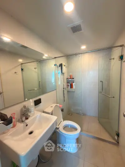 Modern bathroom with glass shower enclosure and sleek fixtures