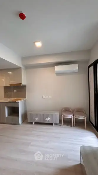 Modern living room with sleek air conditioning and minimalist furniture in a stylish apartment.