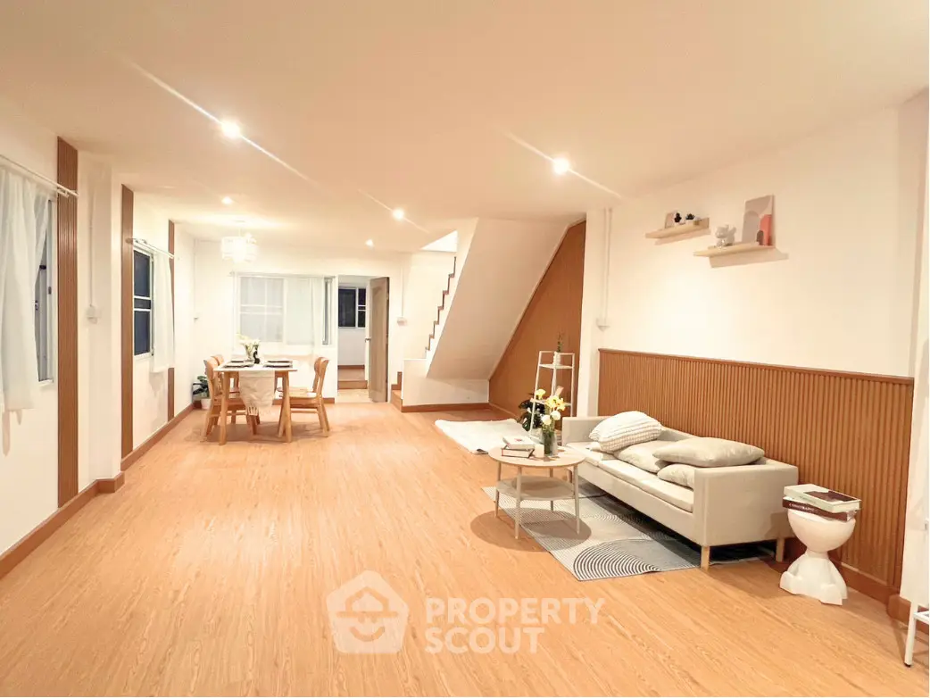Spacious modern living room with elegant decor and open dining area