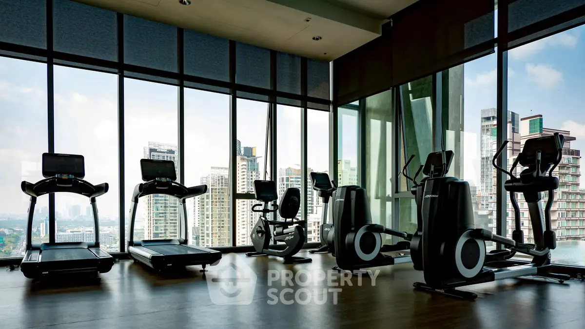 Modern gym with city view and state-of-the-art fitness equipment.