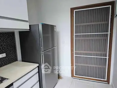 Modern kitchen with sleek fridge and stylish cabinetry