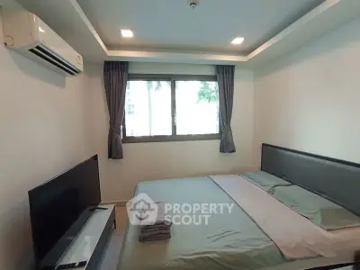 Cozy bedroom with modern decor and ample natural light
