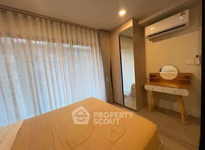 Cozy bedroom with modern decor and air conditioning in a stylish apartment.