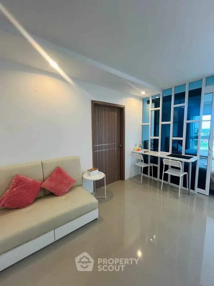 Modern living room with sleek design and stylish furniture, featuring a cozy sofa and chic decor.