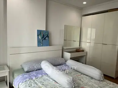 Cozy bedroom with modern white wardrobe and stylish decor