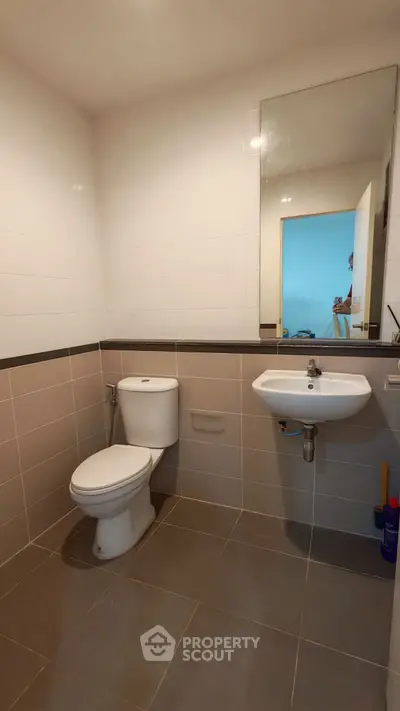 Modern bathroom with sleek fixtures and neutral tiles, ideal for contemporary living.