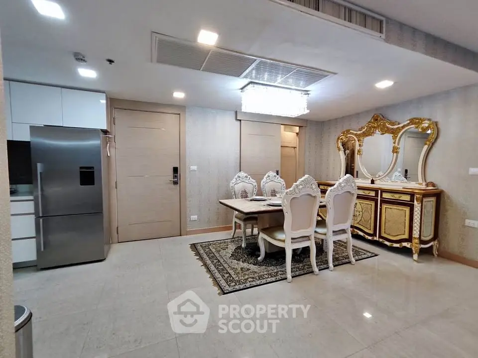 Luxurious dining area with elegant furniture and modern kitchen appliances in a stylish apartment.
