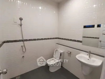 Modern bathroom with sleek white tiles and contemporary fixtures