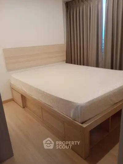 Cozy bedroom with wooden flooring and storage bed frame