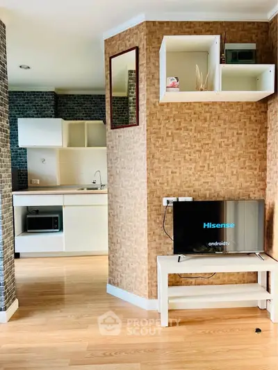 Modern apartment interior with open kitchen and stylish living area featuring a Hisense Android TV.