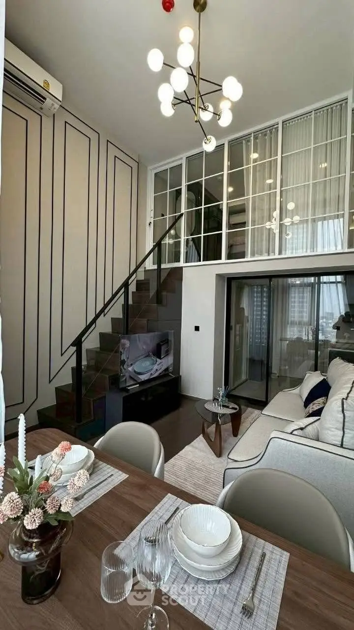 Modern loft apartment with stylish living room and dining area, featuring elegant decor and open layout.