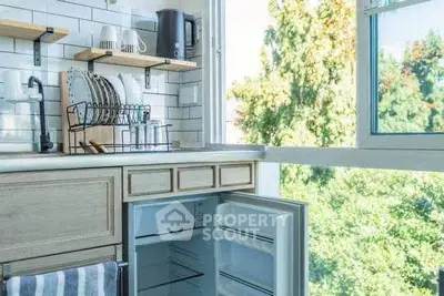 Bright kitchen with open fridge and scenic window view