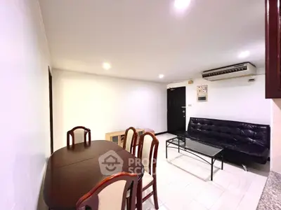 Spacious living room with dining area and modern furniture in a cozy apartment.