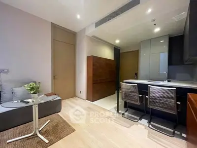Modern living room with open kitchen and stylish furniture in a contemporary apartment.