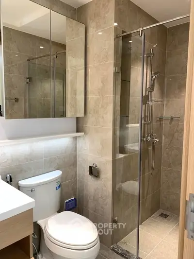 Modern bathroom with glass shower and elegant tile design