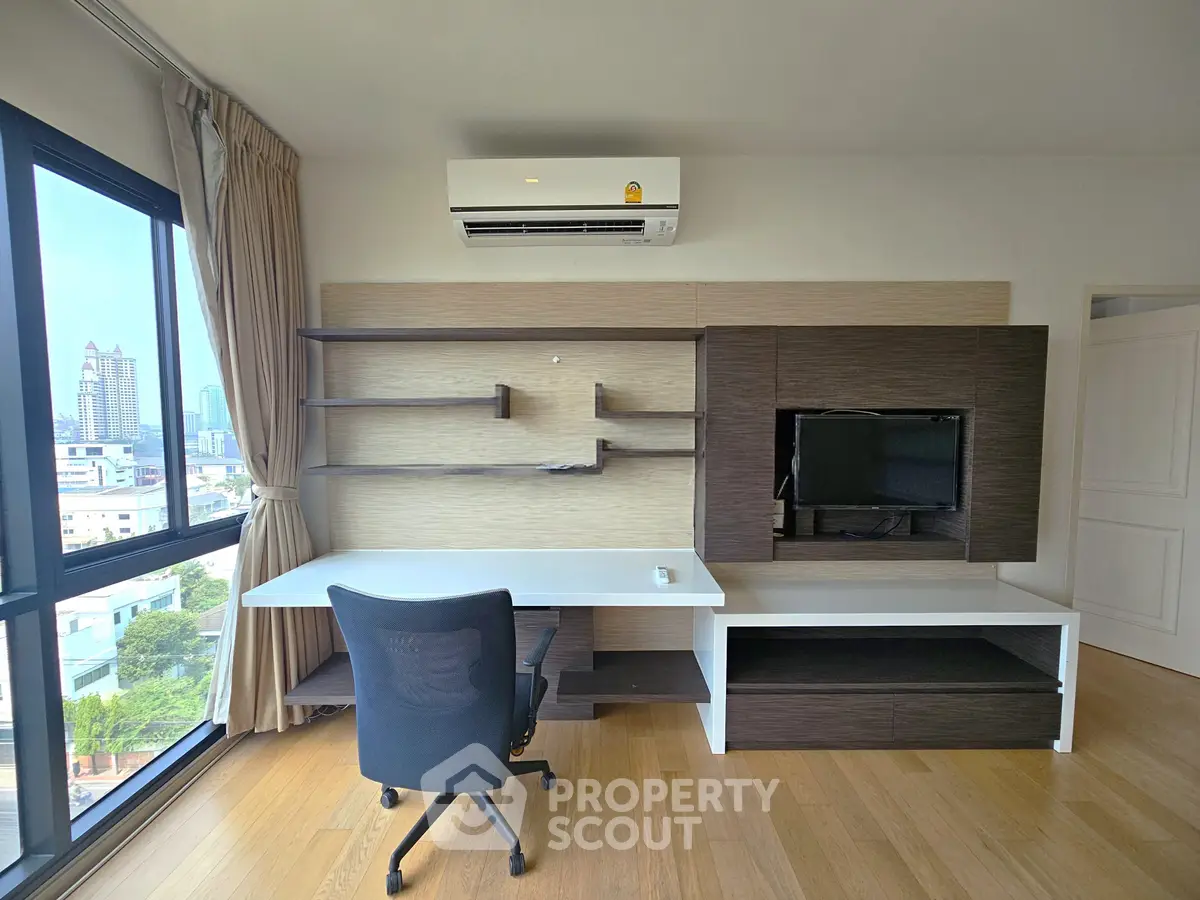 Modern study room with built-in desk and city view window, perfect for productivity.
