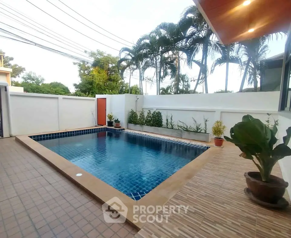 Stunning private pool area with lush greenery and modern design, perfect for relaxation and entertainment.