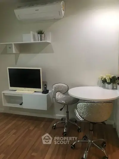 Modern living room with sleek furniture and air conditioning, perfect for a cozy urban lifestyle.