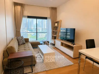 Modern living room with city view, featuring stylish furniture and large window.