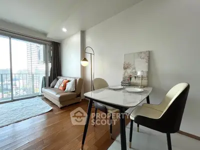Modern living room with dining area and balcony view in a stylish apartment.