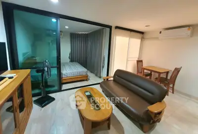 Modern studio apartment with cozy living area and separate bedroom