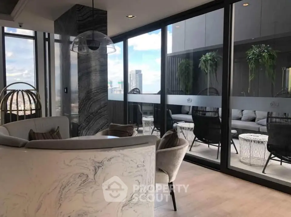Luxurious modern living room with floor-to-ceiling windows and stunning city view, featuring elegant decor and outdoor seating.