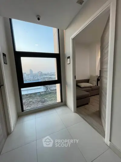 Modern apartment hallway with large window and city view