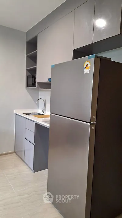 Modern kitchen with sleek cabinets and stainless steel fridge