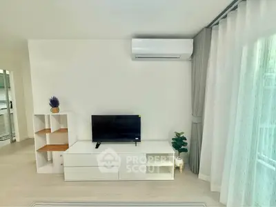 Modern living room with sleek white furniture and air conditioning