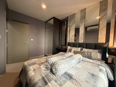 Modern bedroom with stylish decor and mirrored accents