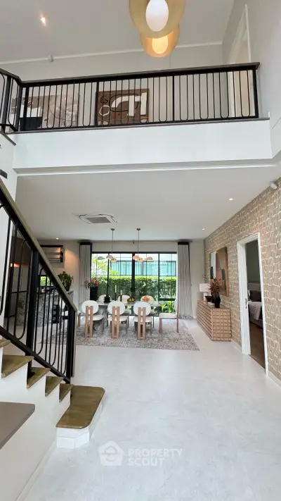 Spacious modern living room with high ceilings and elegant dining area, featuring stylish decor and large windows.