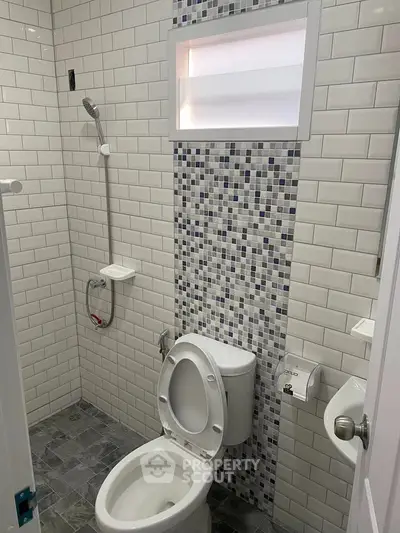 Modern bathroom with stylish tile design and efficient shower setup