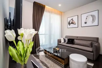 Stylish modern living room with elegant decor and large window view.