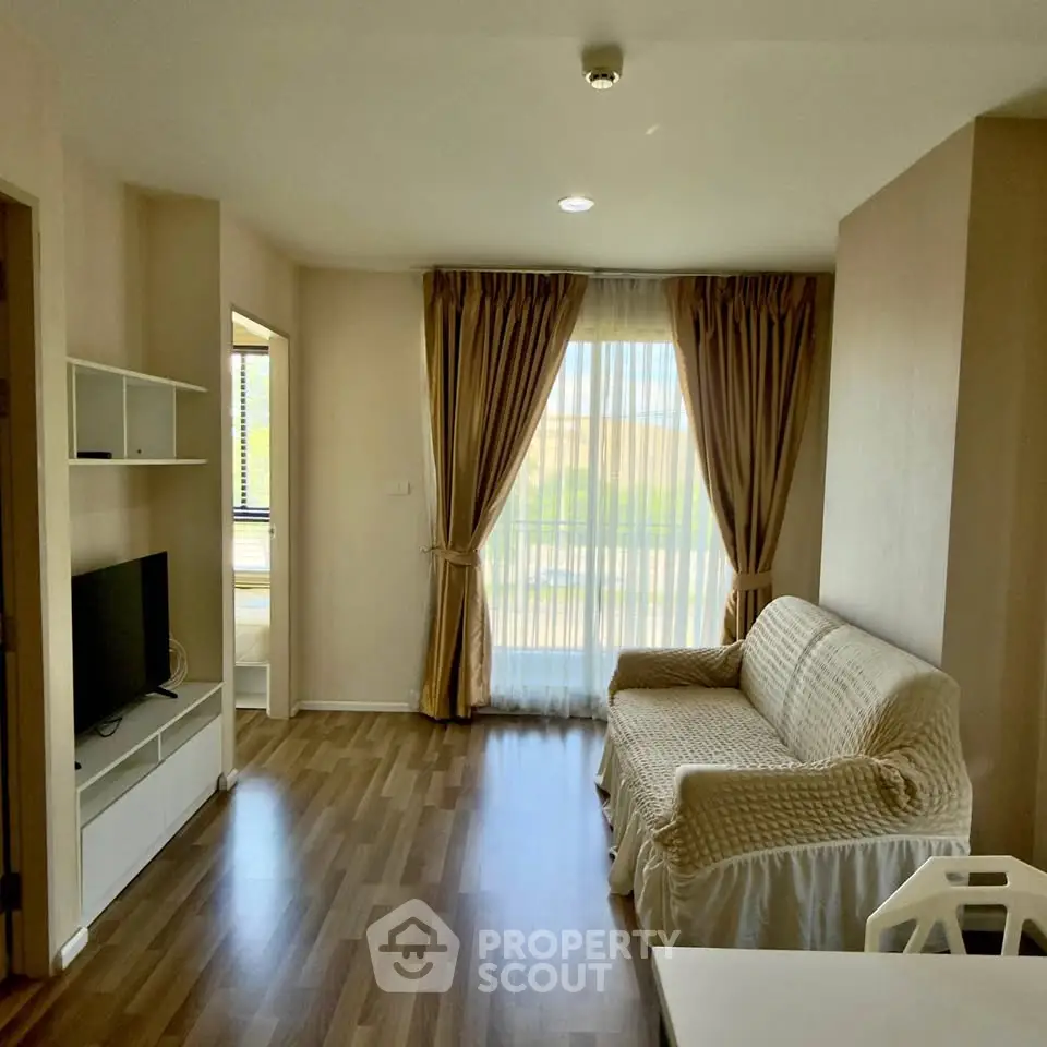 Cozy living room with natural light and elegant curtains in modern apartment.