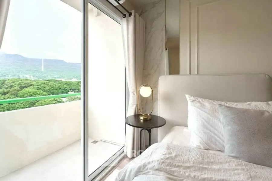 Bright bedroom with balcony view and elegant decor