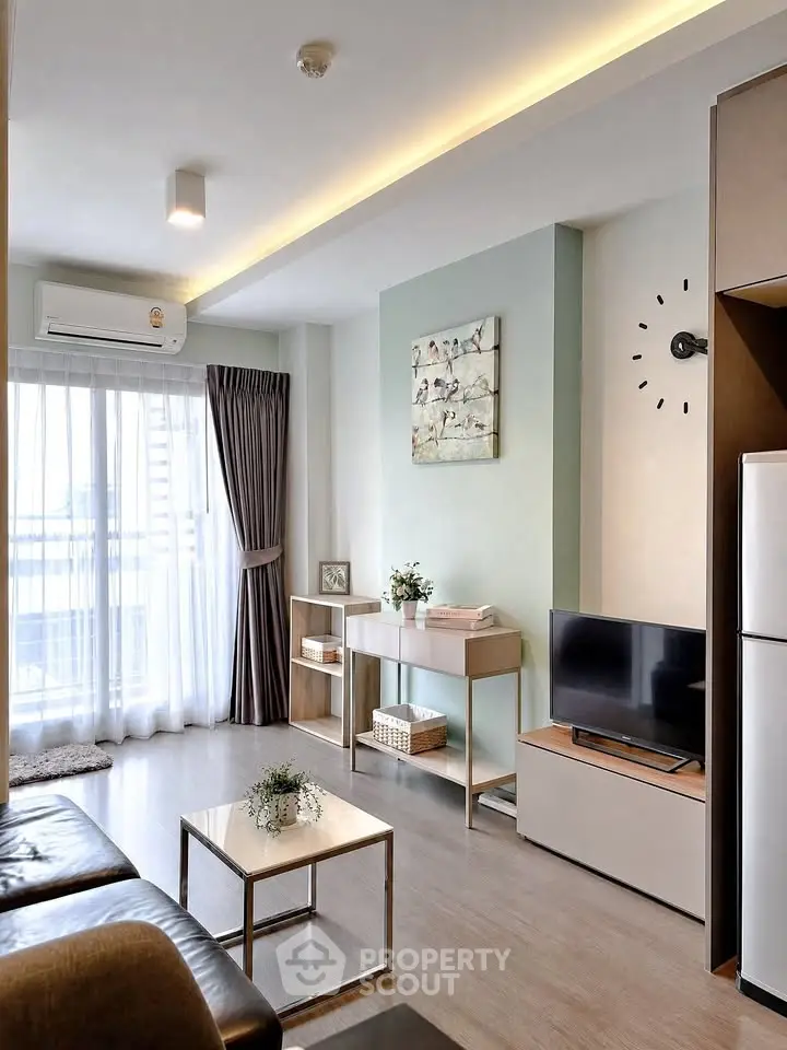 Modern living room with sleek furniture and natural light in a stylish apartment.