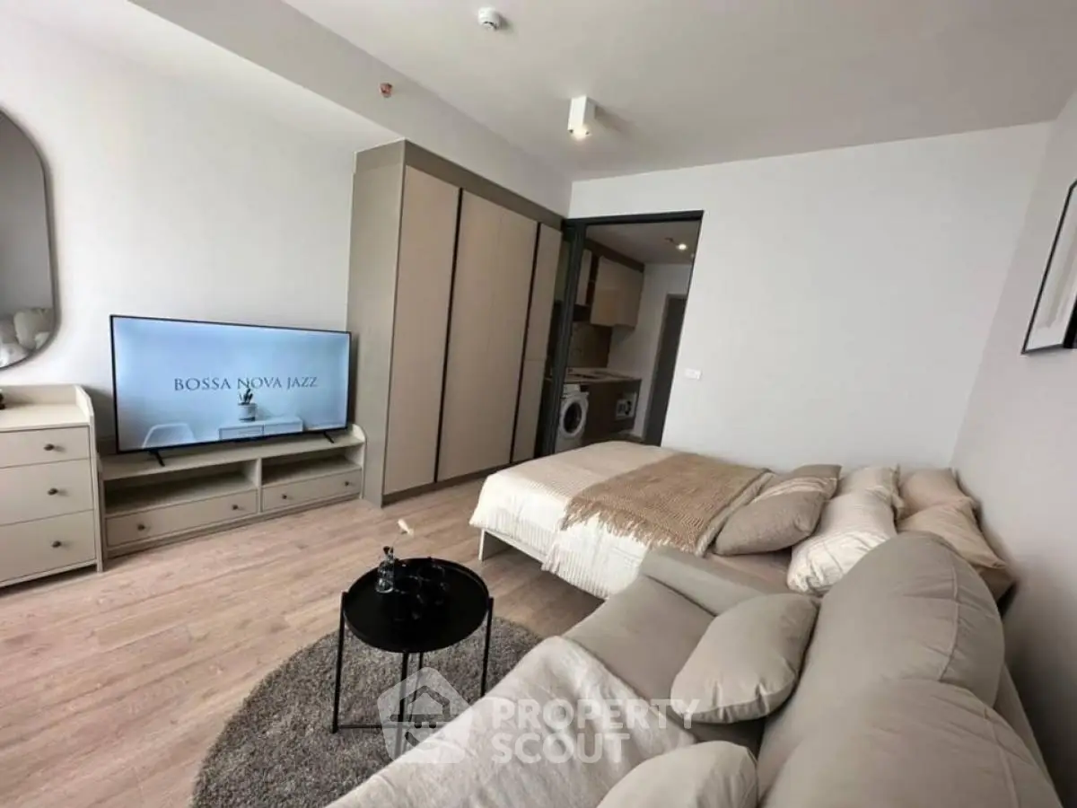 Modern studio apartment with cozy living area and stylish decor