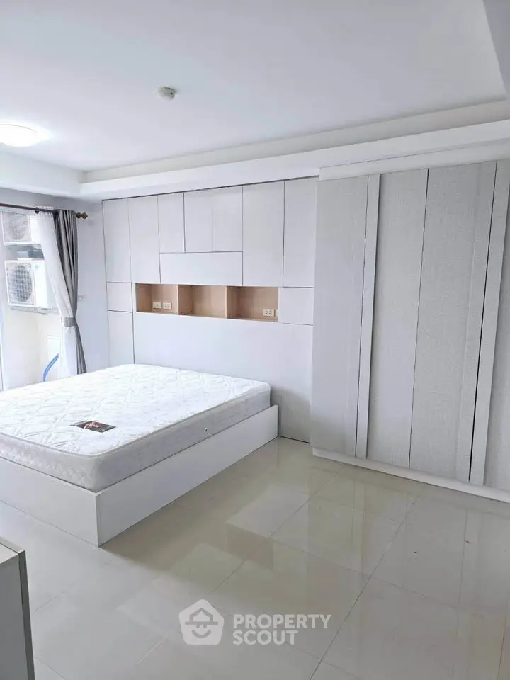 Modern minimalist bedroom with built-in storage and natural light