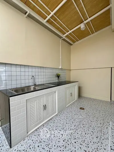 Modern minimalist kitchen with sleek countertops and tiled backsplash