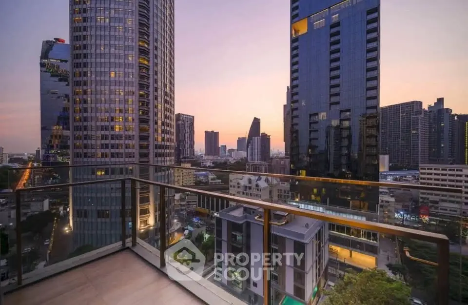Stunning cityscape view from a high-rise balcony at sunset, showcasing modern urban living.