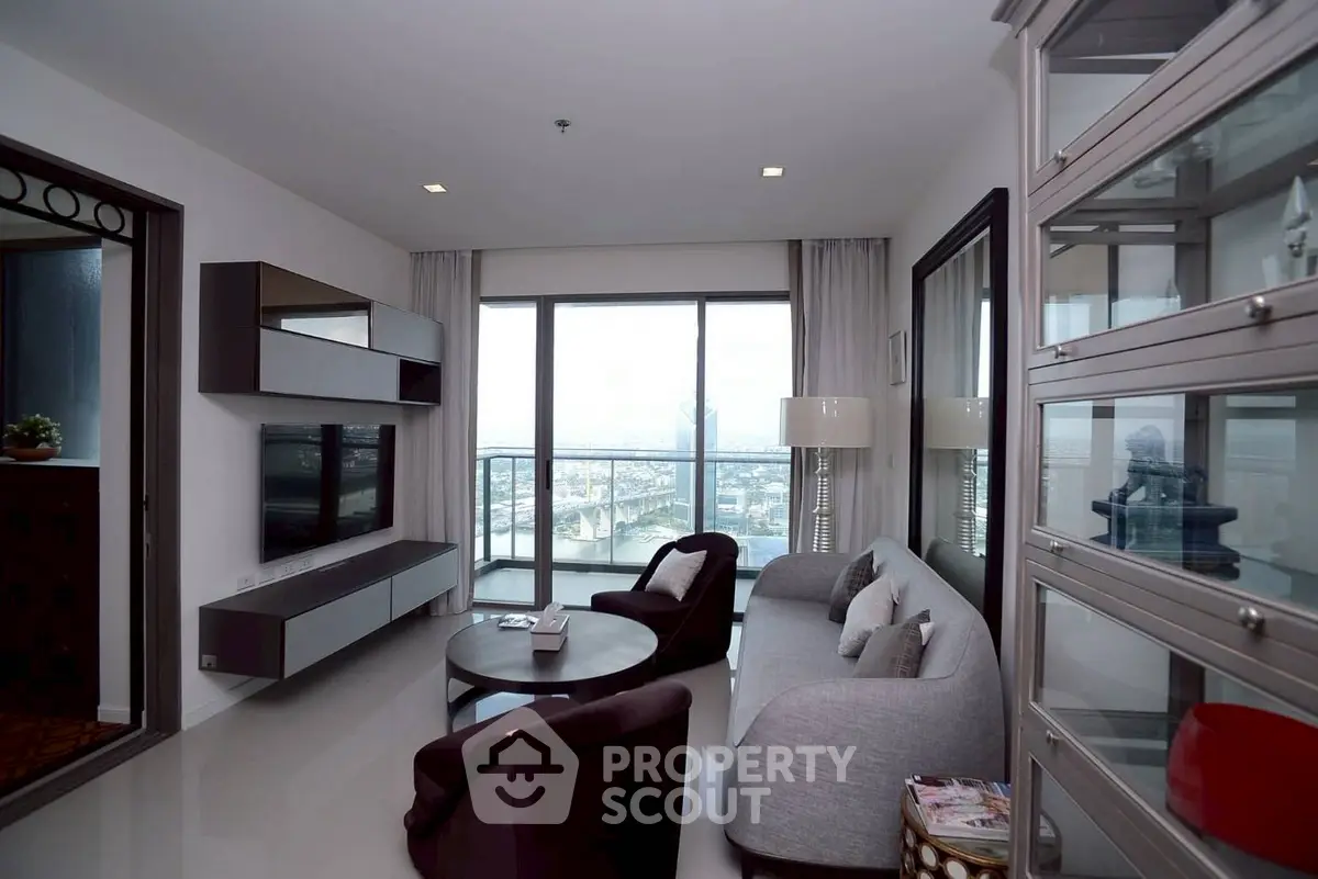 Modern living room with large windows and stylish furniture offering a stunning city view.