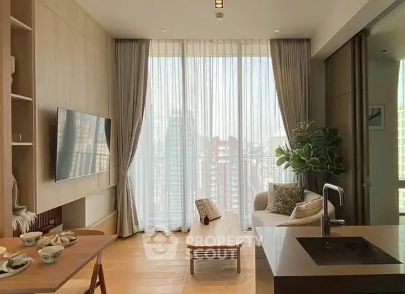 Modern living room with large windows and city view, featuring stylish furniture and open layout.