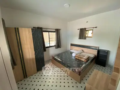 Spacious bedroom with modern furnishings and ample natural light
