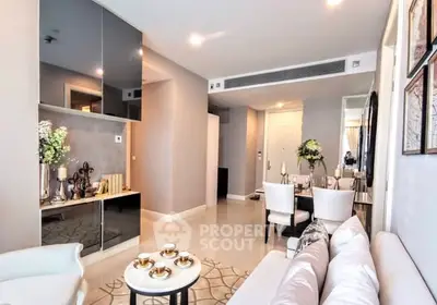 Modern living room with elegant decor and dining area, featuring sleek furniture and ambient lighting.