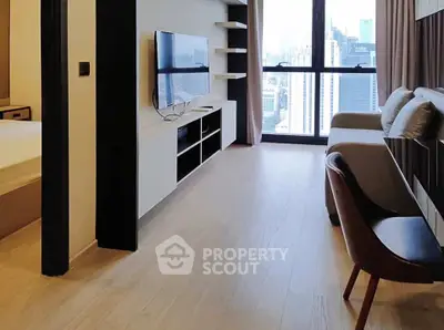 Modern living room with city view, sleek furniture, and natural light.